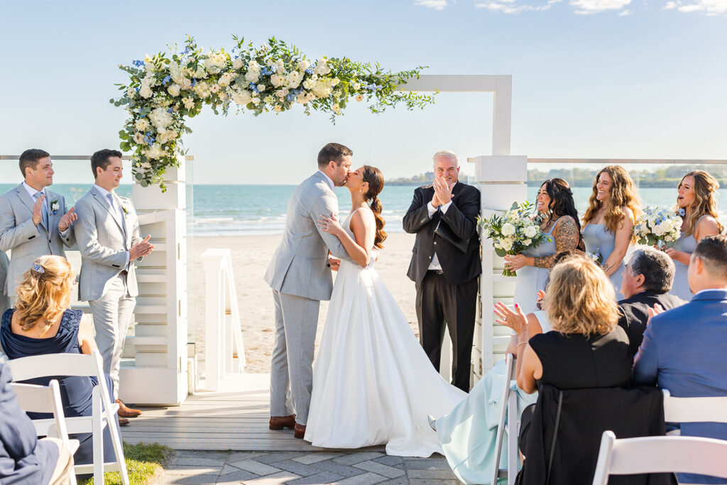 bride and groom first kiss at heir oceanfront ceremony at Newport Beach House.
