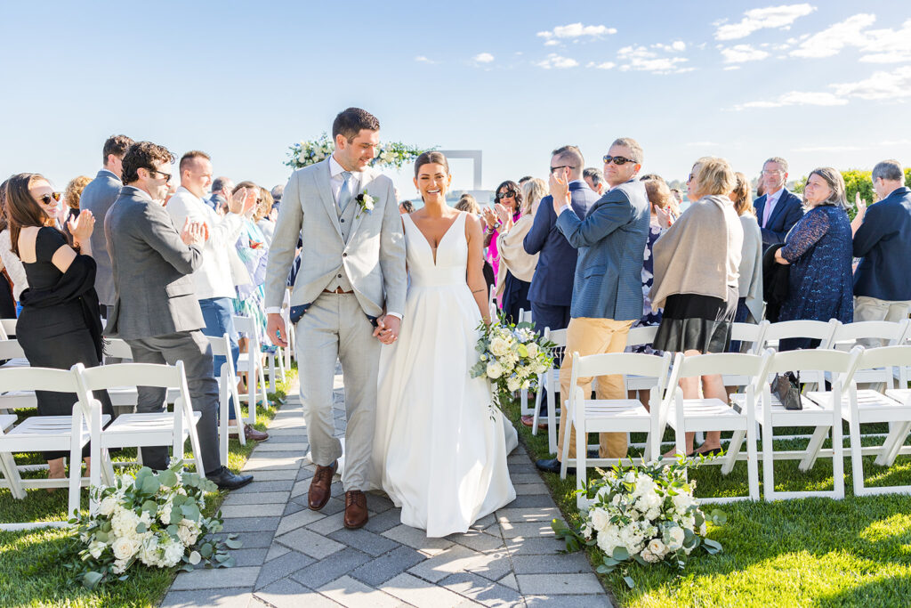 ride and groom walking down the aisle after their oceanfront ceremony at Newport Beach House.
