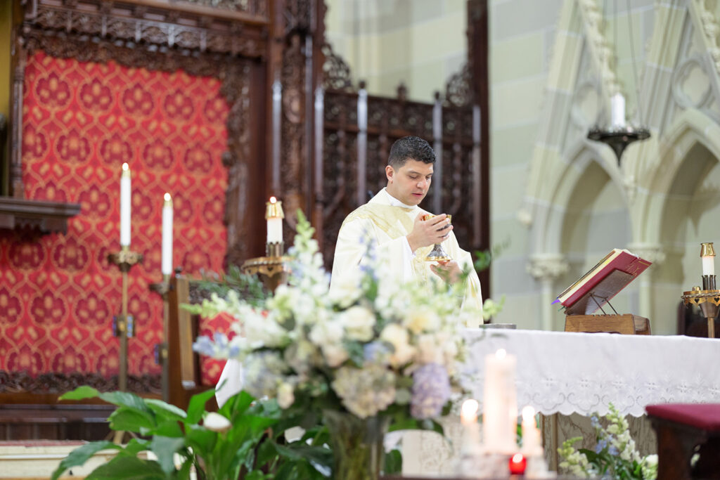 Catholic wedding ceremony at St. Mary's Church in Newport Rhode Island with priest at the altar