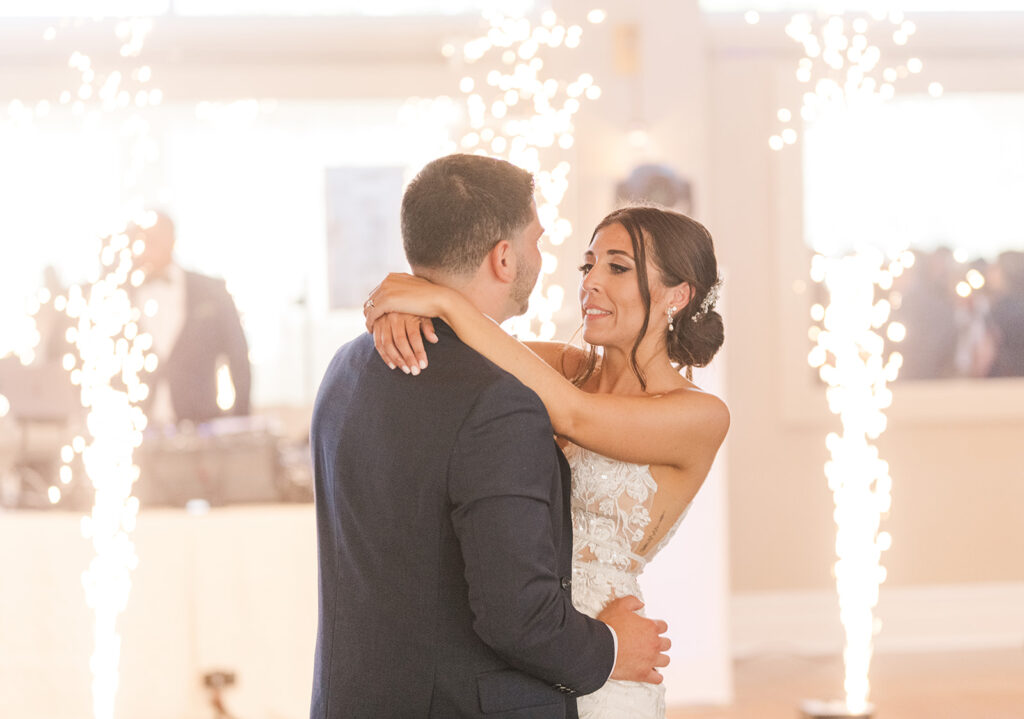 Bride and groom sharing their first dance with indoor sparklers at Wyndham Newport Hotel reception.