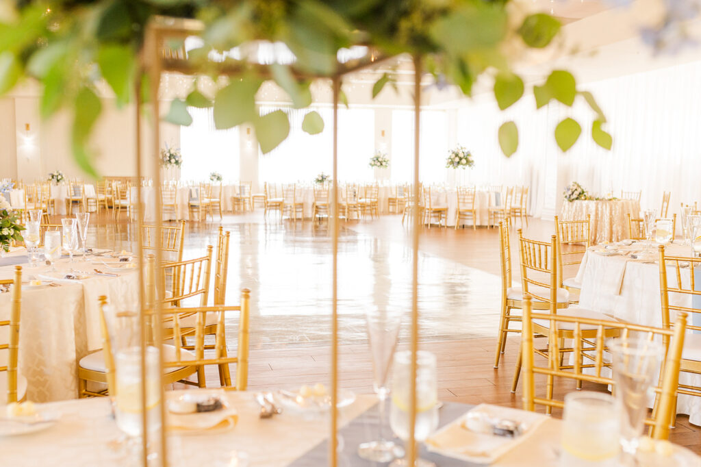 Wedding reception setup with gold chiavari chairs at Wyndham Newport Hotel in Middletown, Rhode Island.


