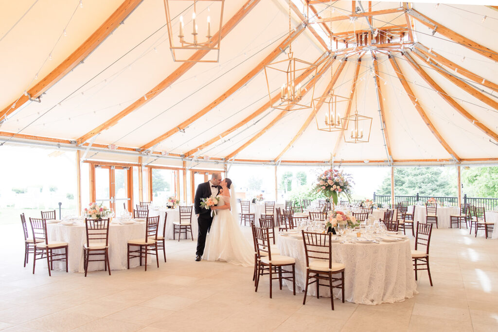 Bride and groom kissing under the sailcloth tent at Castle Hill Inn in Newport Rhode Island