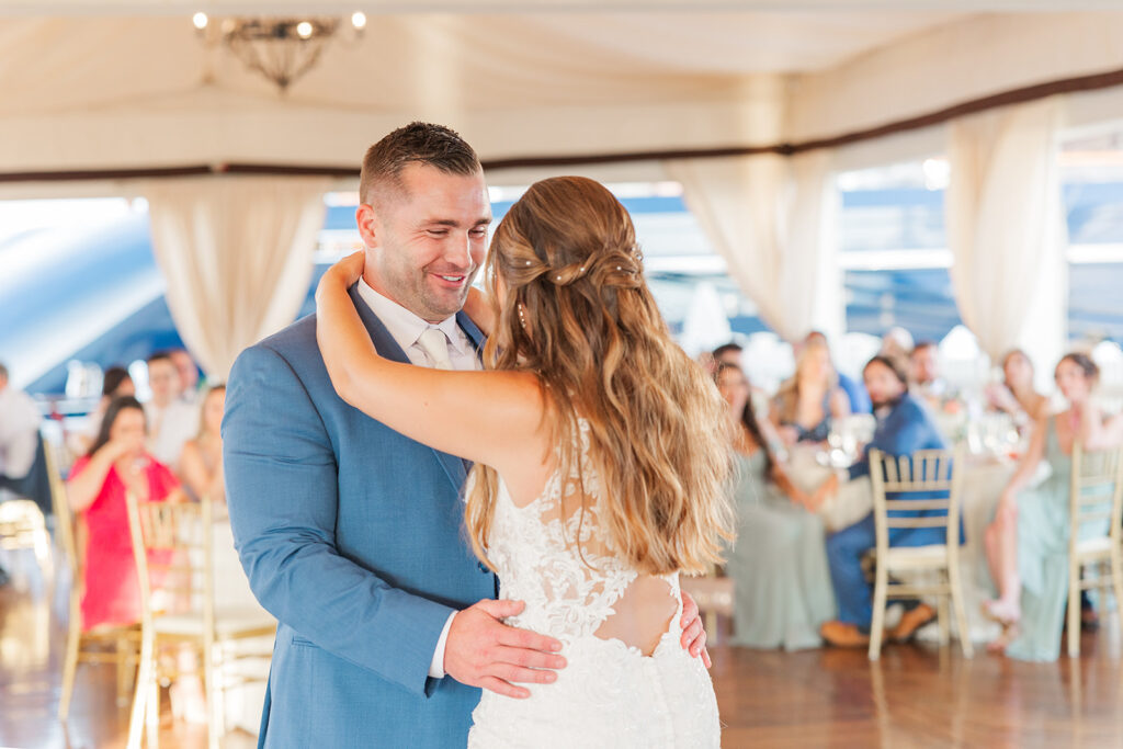 Bride and groom share their first dance inside the reception tent at Regatta Place in Newport, Rhode Island.