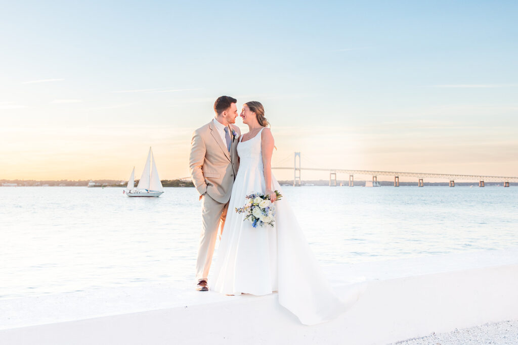Bride and groom portrait at Belle Mer in Newport Rhode Island with the Newport Pell Bridge in the background