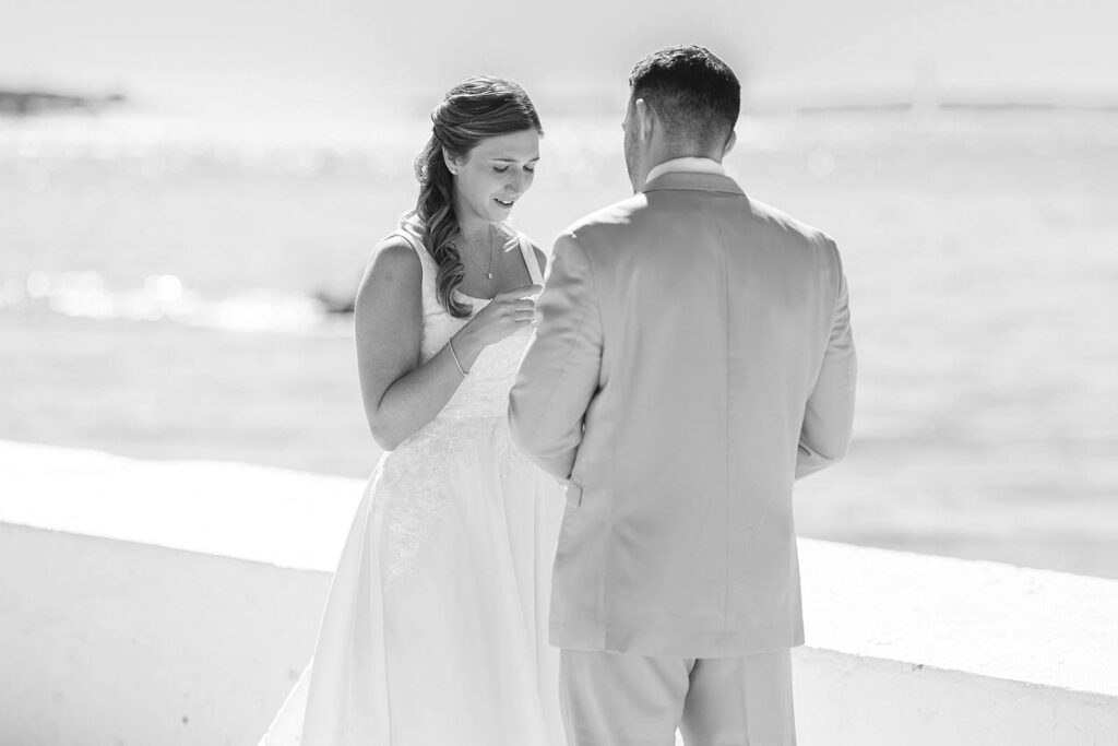 Black and white photograph of bride reading private vows during an emotional first look at Belle Mer
