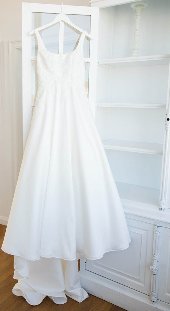 Wedding gown hanging in bridal suite window at Belle Mer in Newport Rhode Island