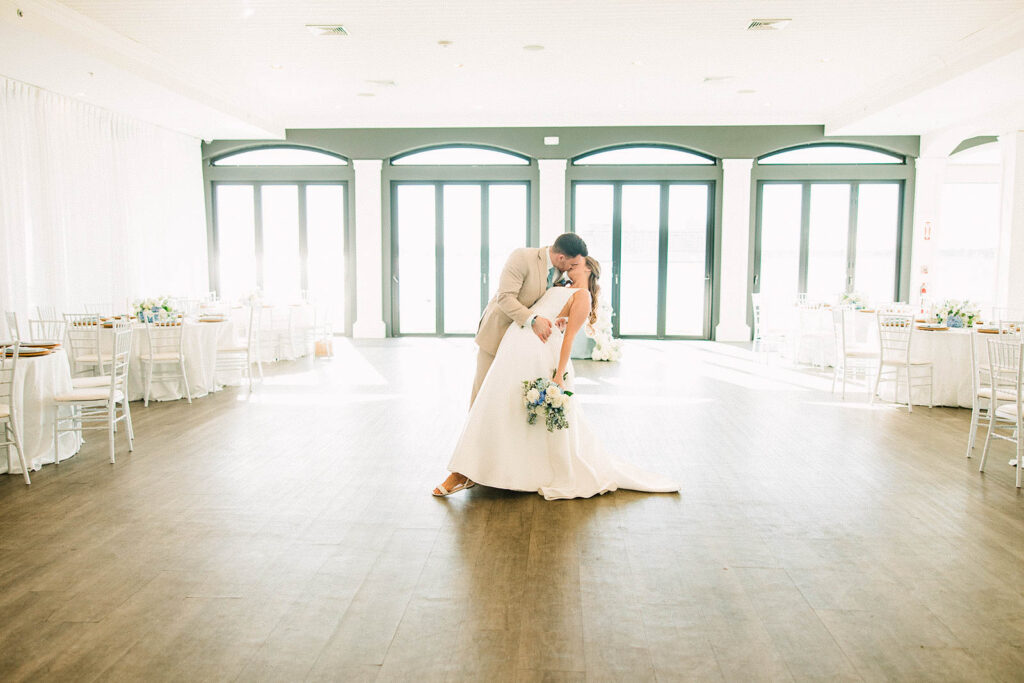 Bride and groom portrait inside Belle Mer’s waterfront reception space before guests enter
