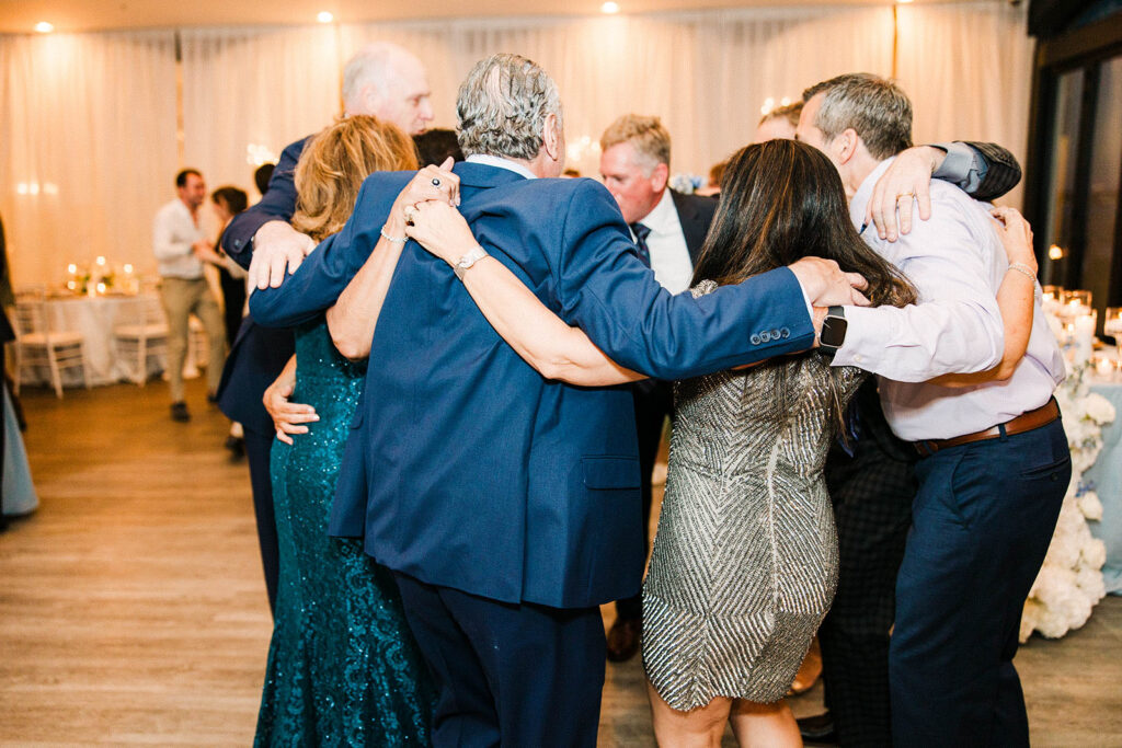 Family members embracing during Belle Mer reception celebration