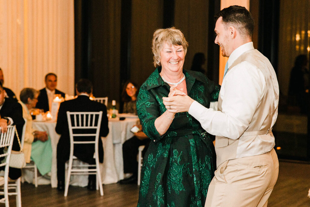 Mother and son dance during Belle Mer wedding reception