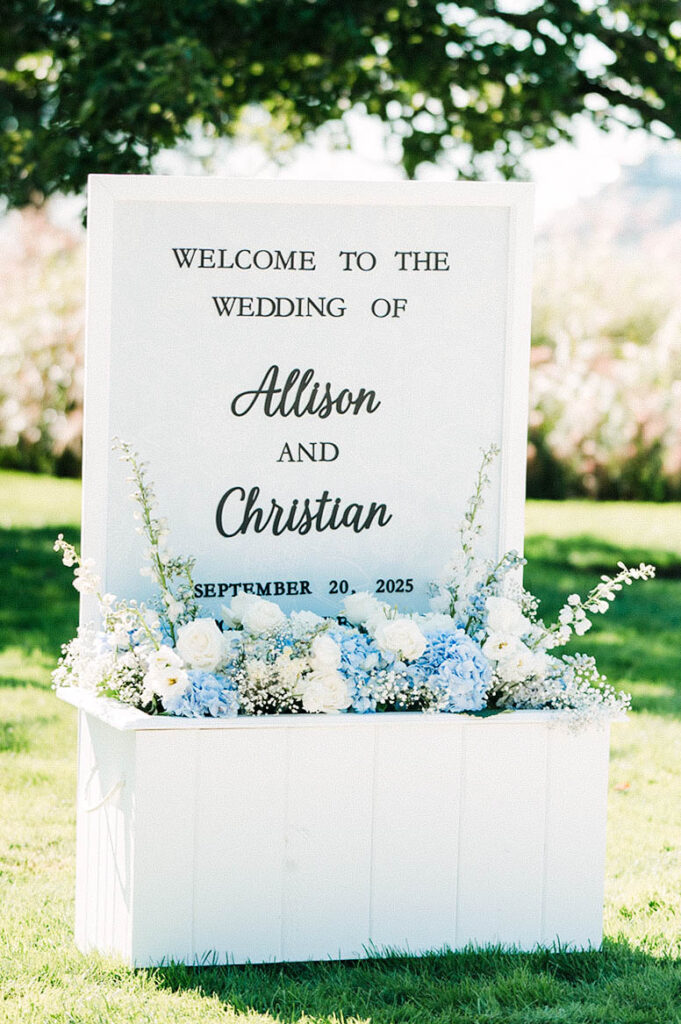 Custom wedding welcome sign with blue and white florals at Belle Mer in Newport Rhode Island