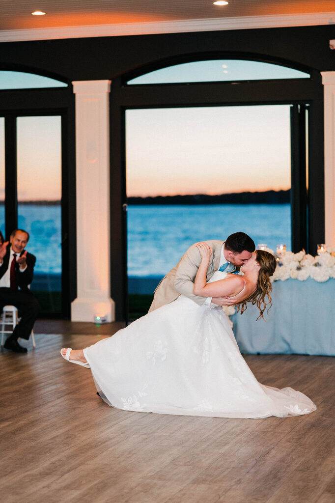 Bride and groom share their first dance inside Belle Mer reception ballroom