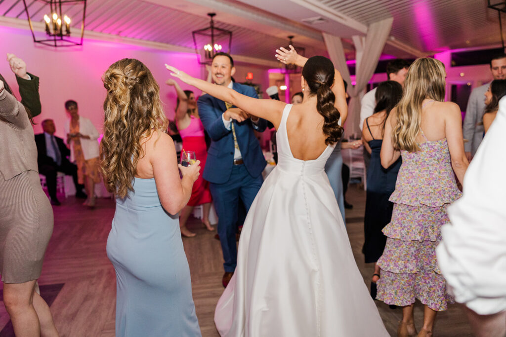 Bride dancing with guests during Newport Beach House wedding reception in Newport Rhode Island
