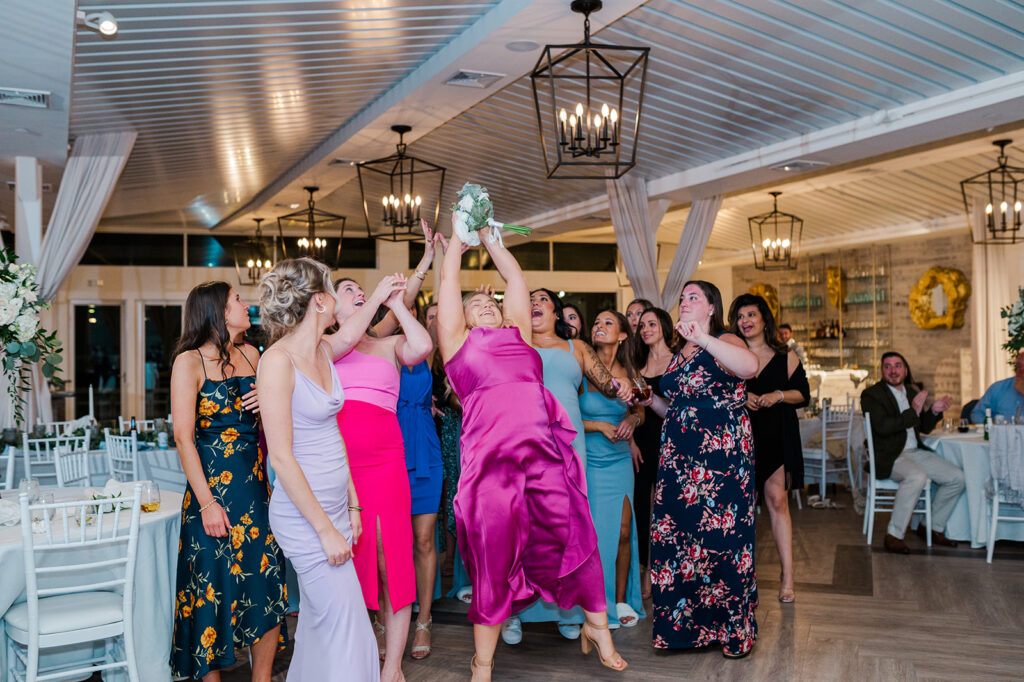 Bride tossing bouquet during Newport Beach House wedding reception in Newport Rhode Island
