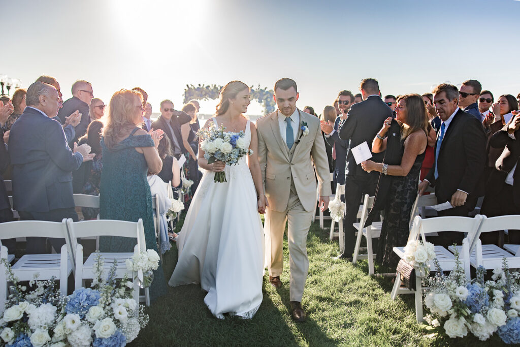 Bride and groom walking back up the aisle after ceremony at Belle Mer in Newport Rhode Island