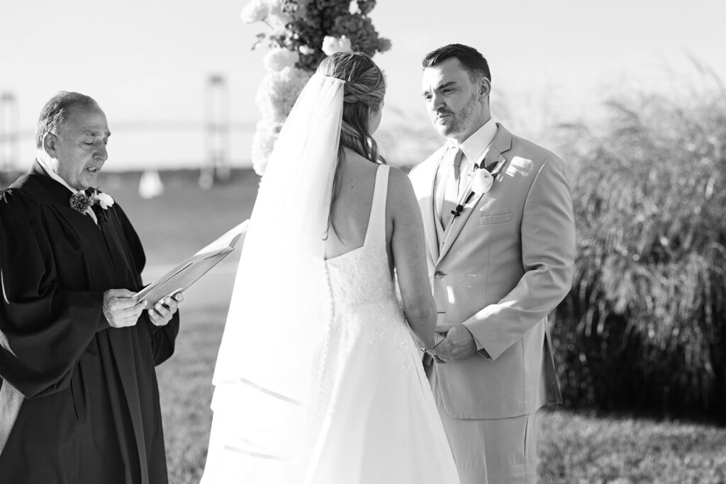 Bride and groom exchanging vows during waterfront Belle Mer wedding ceremony in Newport Rhode Island

