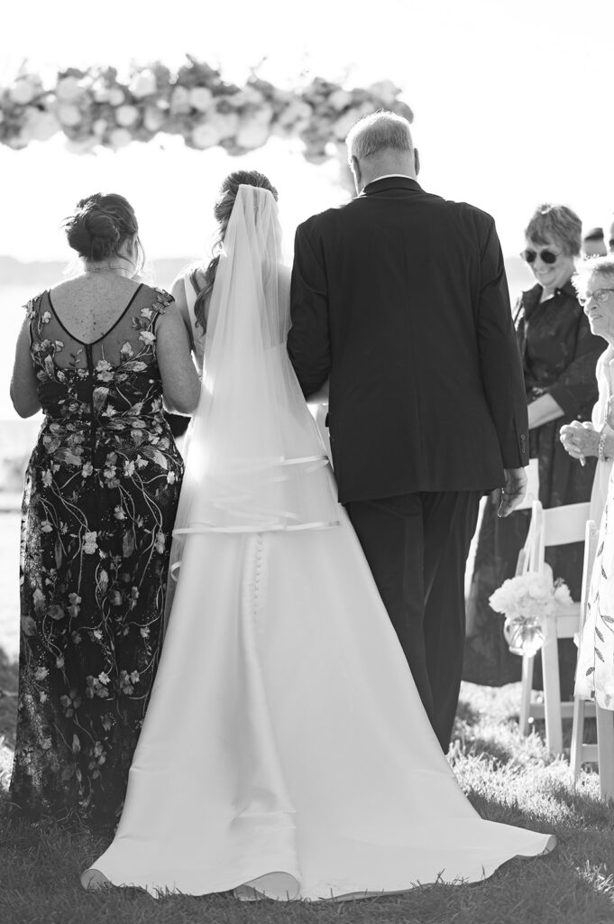 Bride walking down the aisle during waterfront ceremony at Belle Mer in Newport Rhode Island