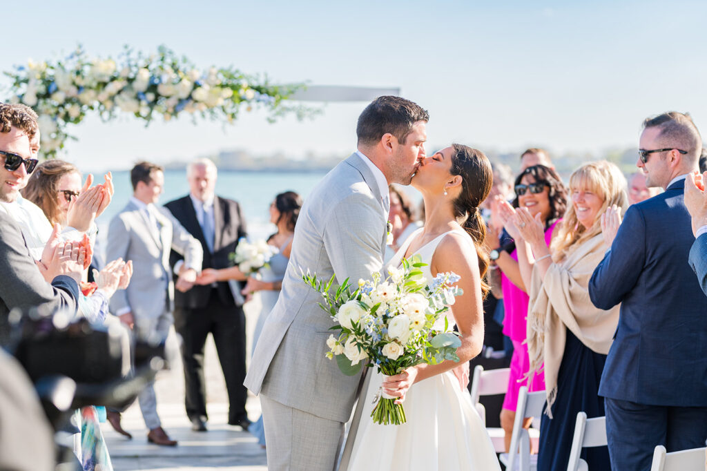 Bride and groom celebrating recessional at Newport Beach House oceanfront wedding ceremony