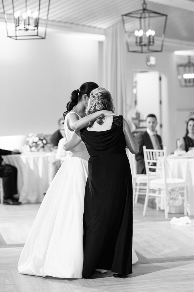 Bride sharing an emotional dance with her mother during Newport Beach House wedding reception