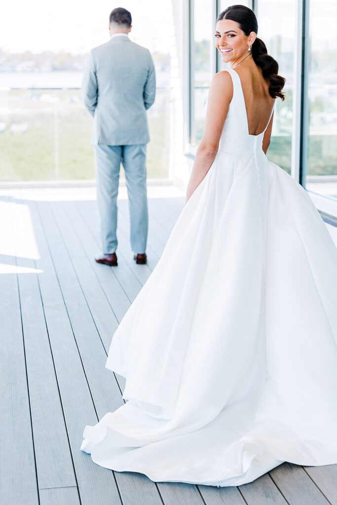 Bride approaching groom for a private first look at Newport Beach House in Rhode Island

