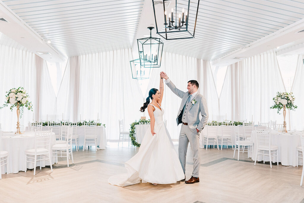 Couple privately viewing bright oceanfront reception room at Newport Beach House before wedding celebration