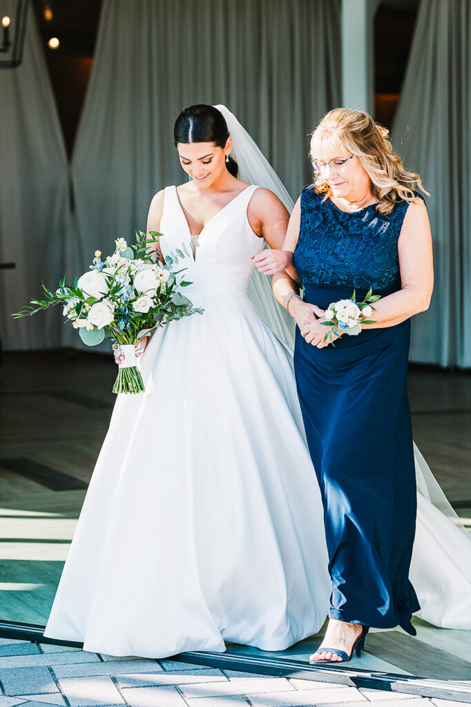 Bride walking down the aisle with her mother at Newport Beach House wedding ceremony