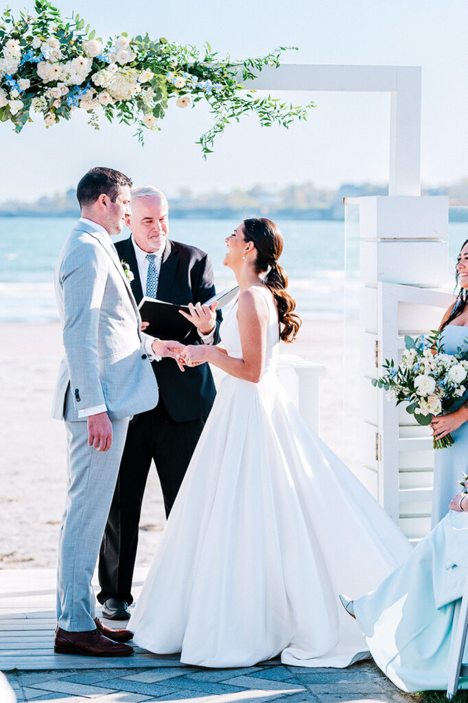 Bride and groom exchanging vows during oceanfront ceremony at Newport Beach House