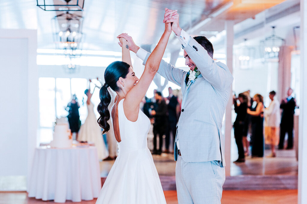 Bride and groom celebrating on the dance floor during Newport Beach House wedding reception