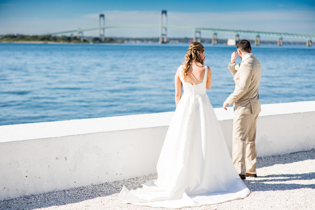 Bride and groom sharing private vows with the Newport Bridge behind them at Belle Mer
