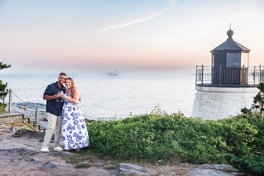 couple embracing after proposal at Castle Hill Lighthouse in Newport Rhode Island
