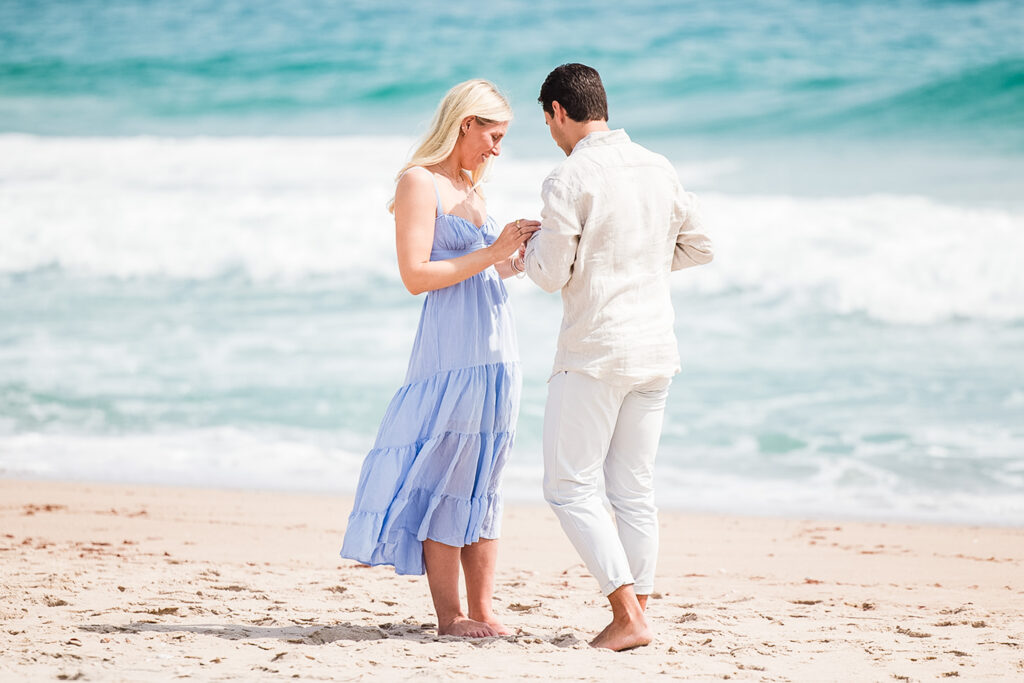 Romantic beach proposal in Rhode Island with ocean backdrop