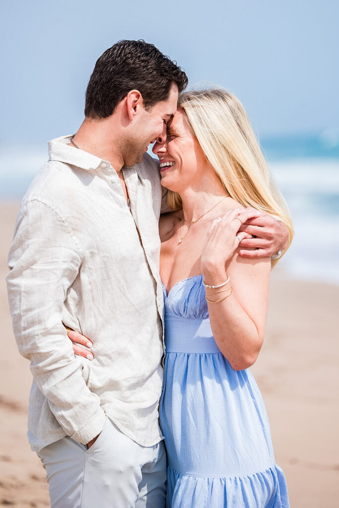 Romantic beach proposal in Rhode Island with ocean backdrop