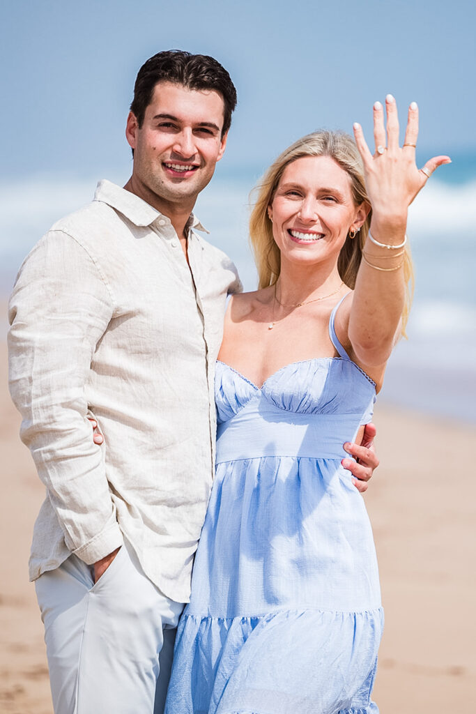 Romantic beach proposal in Rhode Island with ocean backdrop