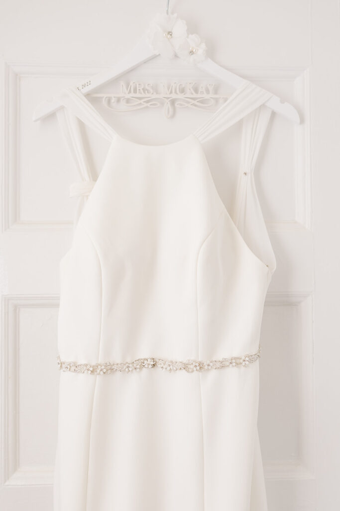 Wedding dress hanging in the getting-ready space at OceanCliff