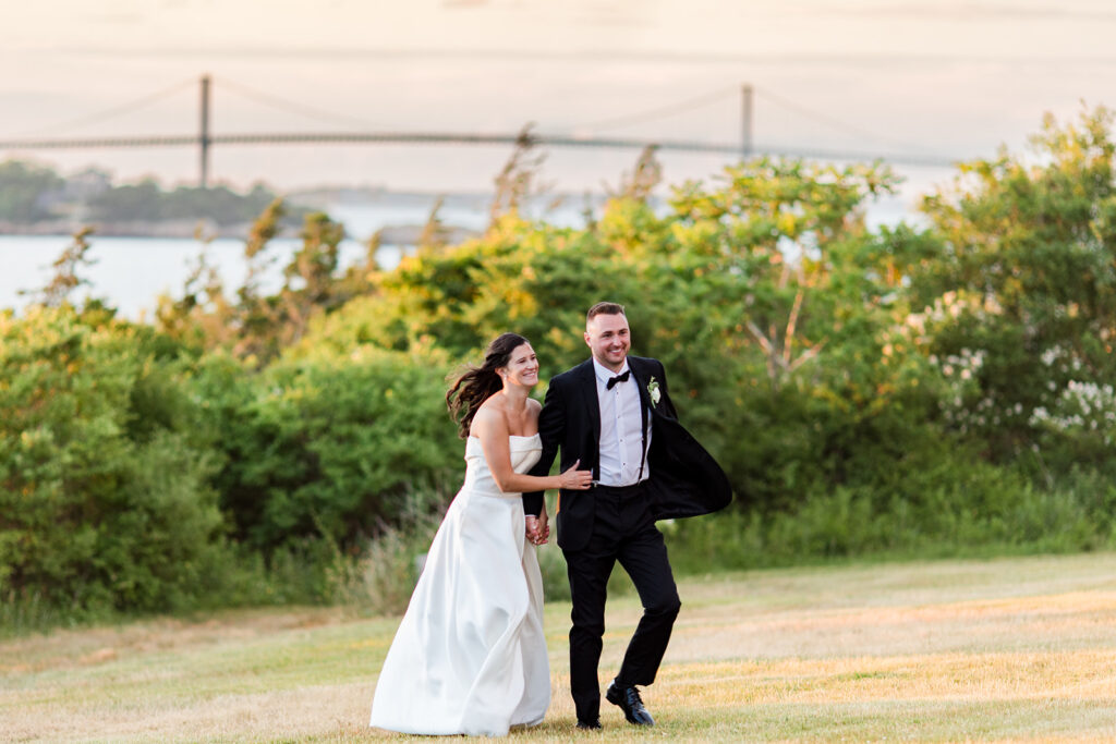 Bride and groom with the Pell Bridge in the background at OceanCliff