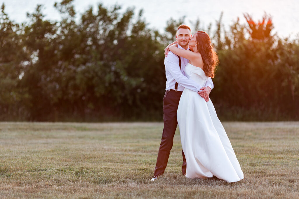 Bride and groom sharing a quiet sunset portrait at OceanCliff in Newport