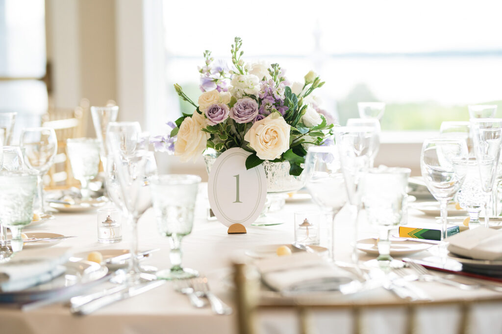 Floral centerpiece and table number at an OceanCliff wedding reception