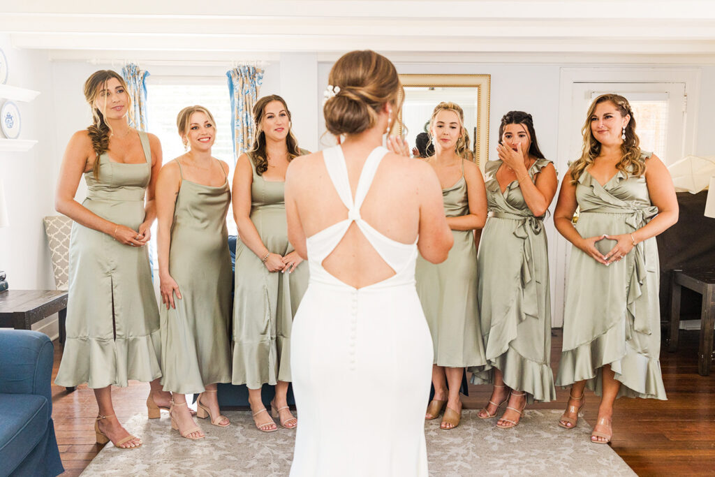 First look with bridesmaids in the getting-ready space at OceanCliff