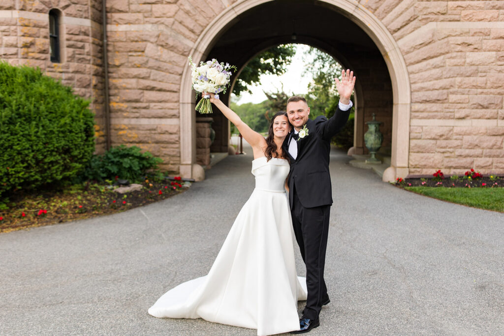 Bride and groom under the stone arch at OceanCliff in Newport, Rhode Island